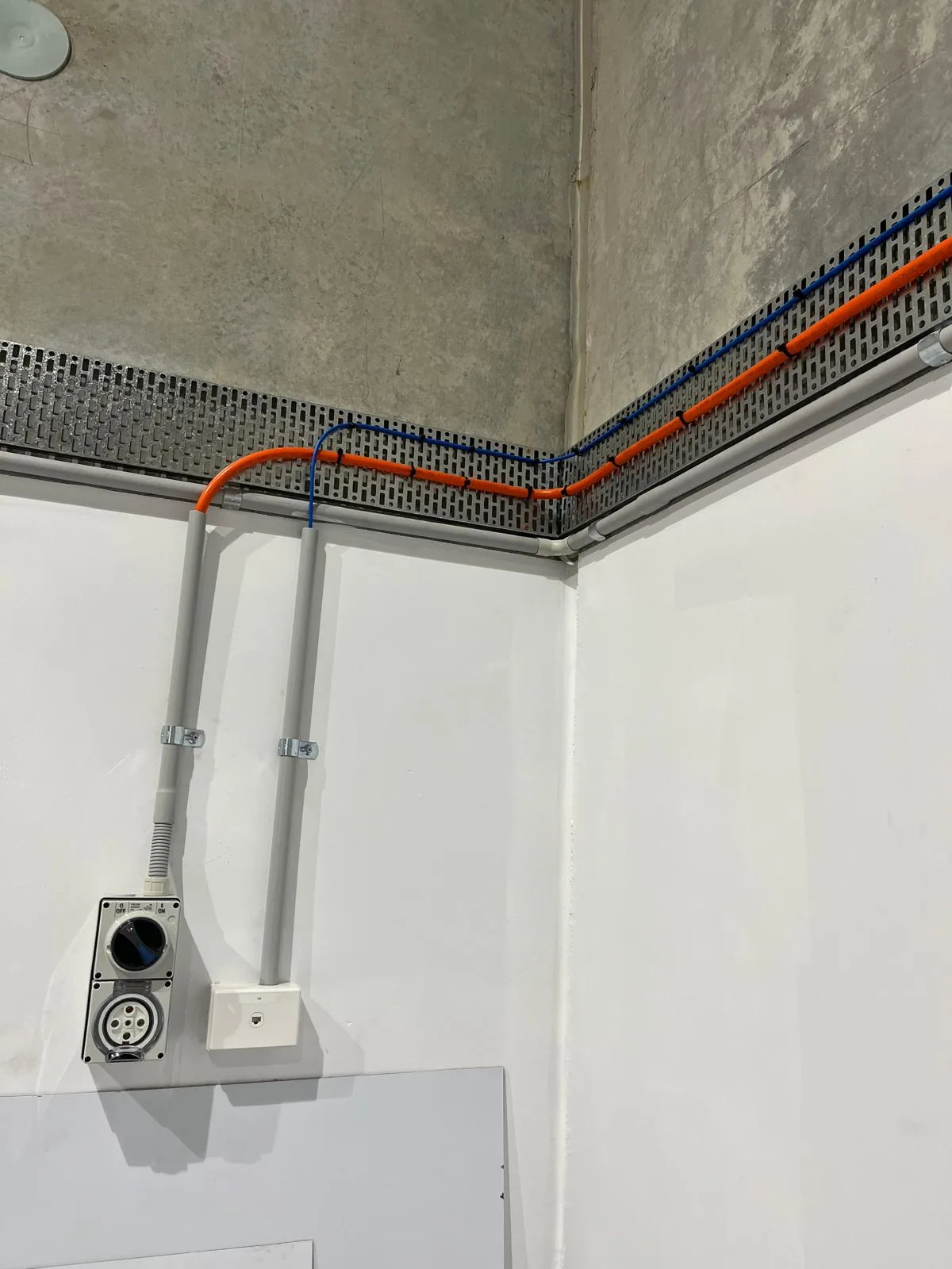 A three-phase outlet and data point on a clean conduit run at a commercial premises