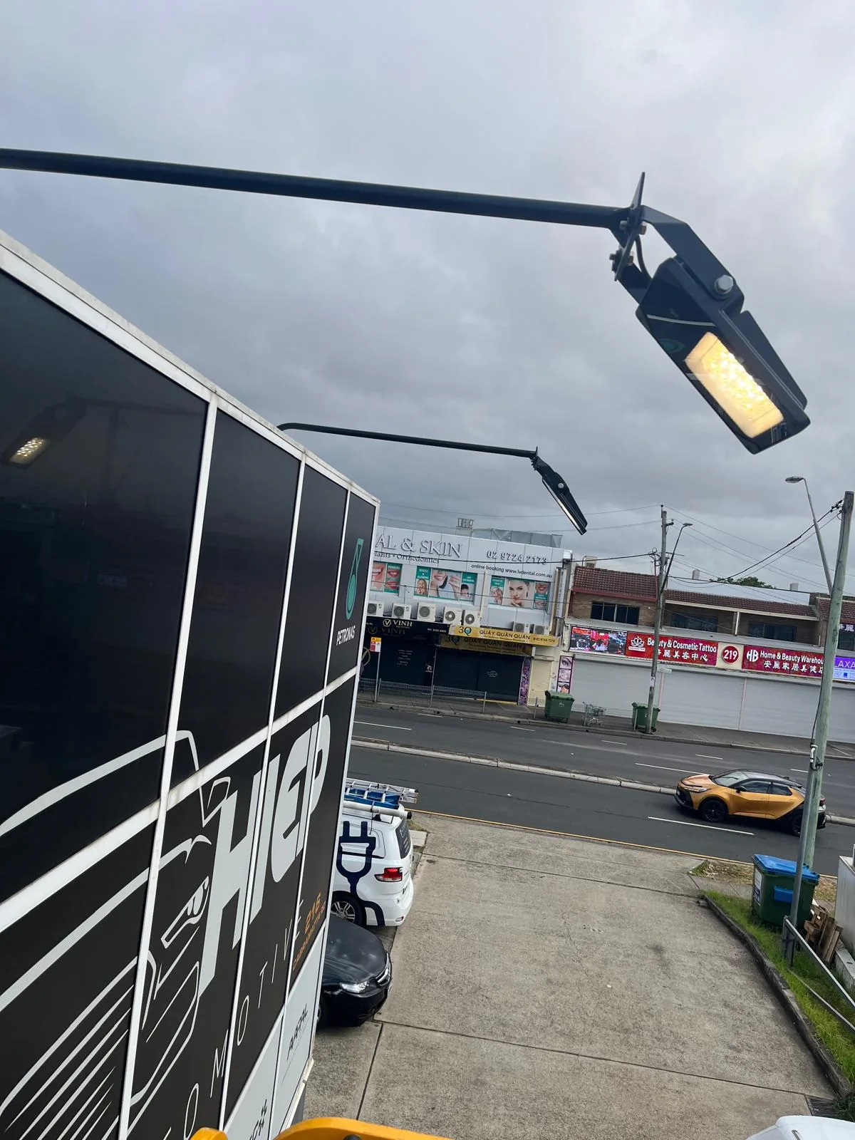 Pole-mounted LED floodlights lighting a commercial carpark