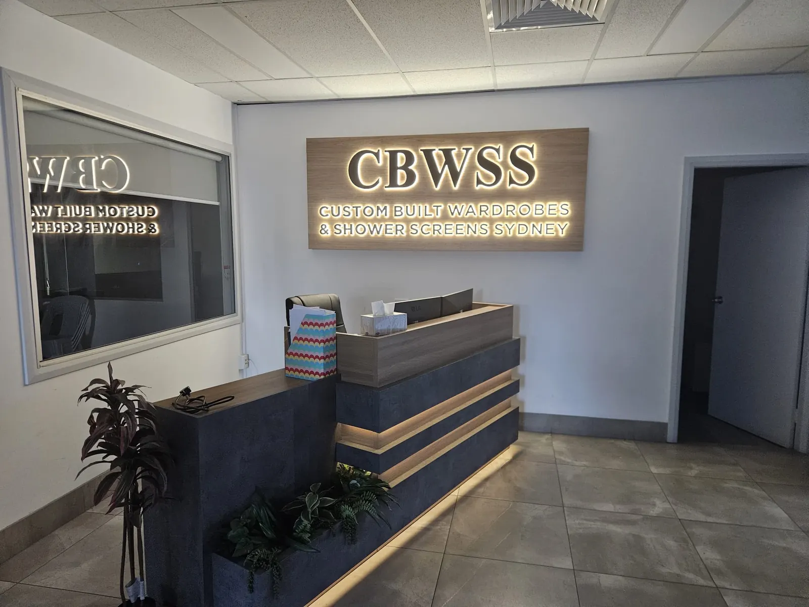 Finished reception fit-out with backlit signage, downlights and under-counter lighting