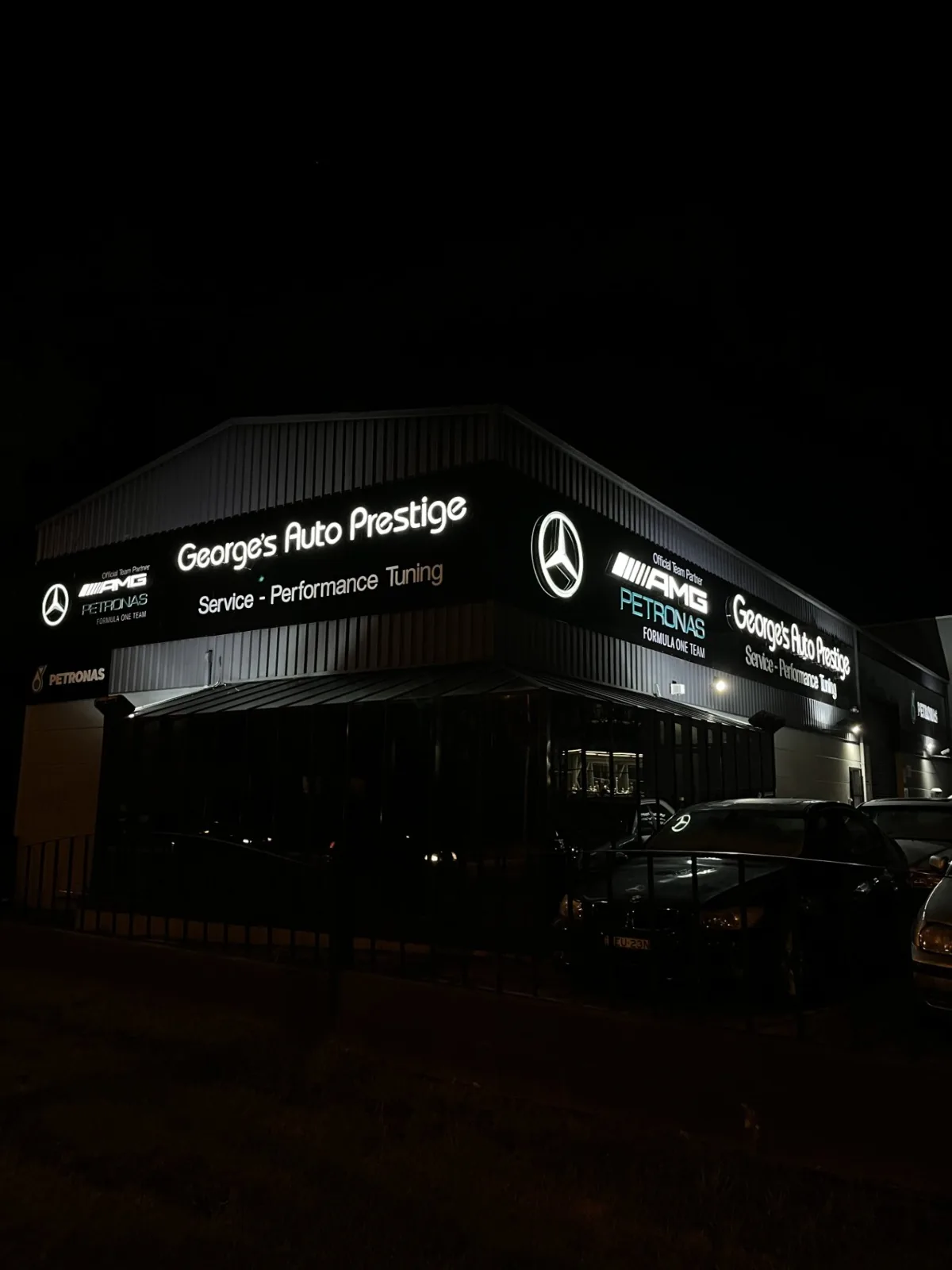 Illuminated shopfront signage at night