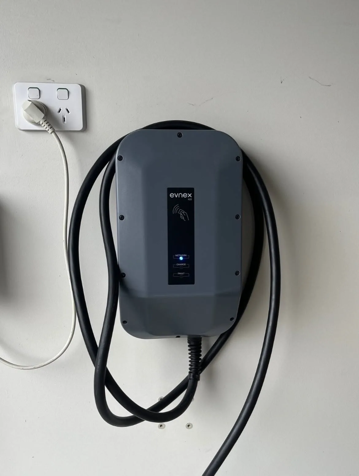 A wall-mounted EV charger installed by C3 Industries, close up