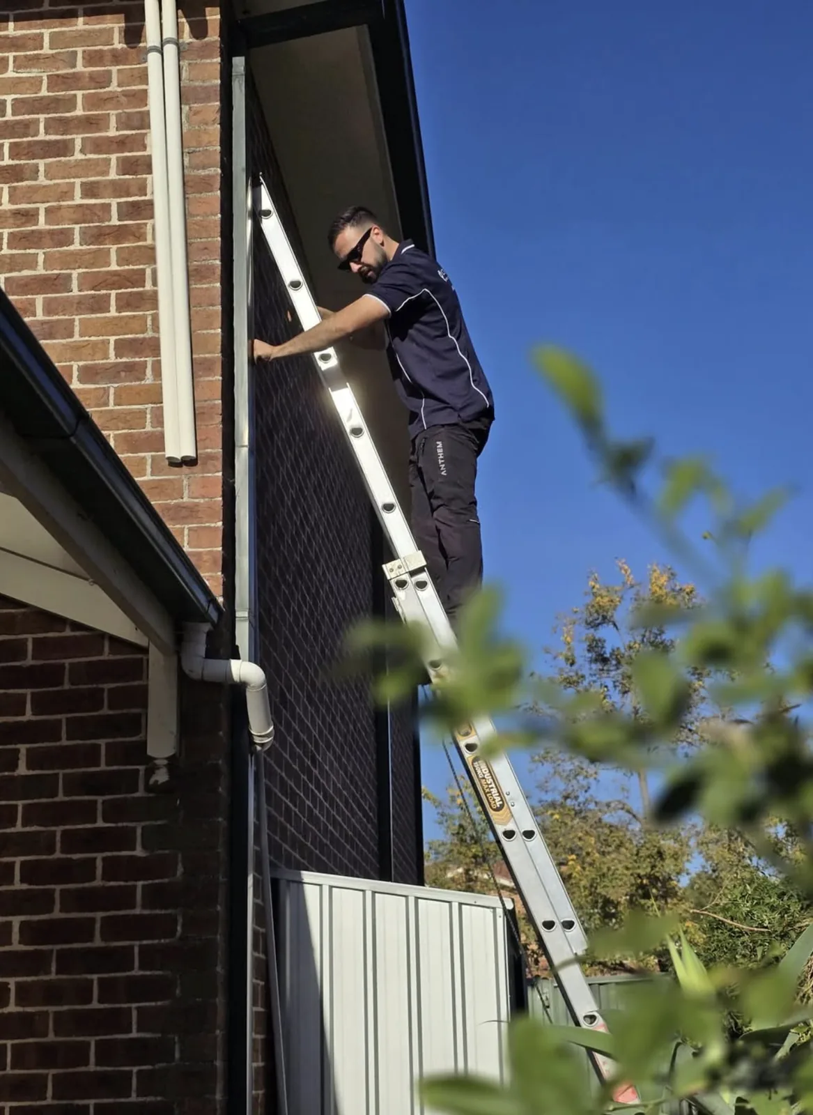 Kalin from C3 Industries working at the eaves of a Macarthur home