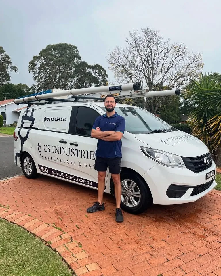 Kalin standing in front of the C3 Industries van