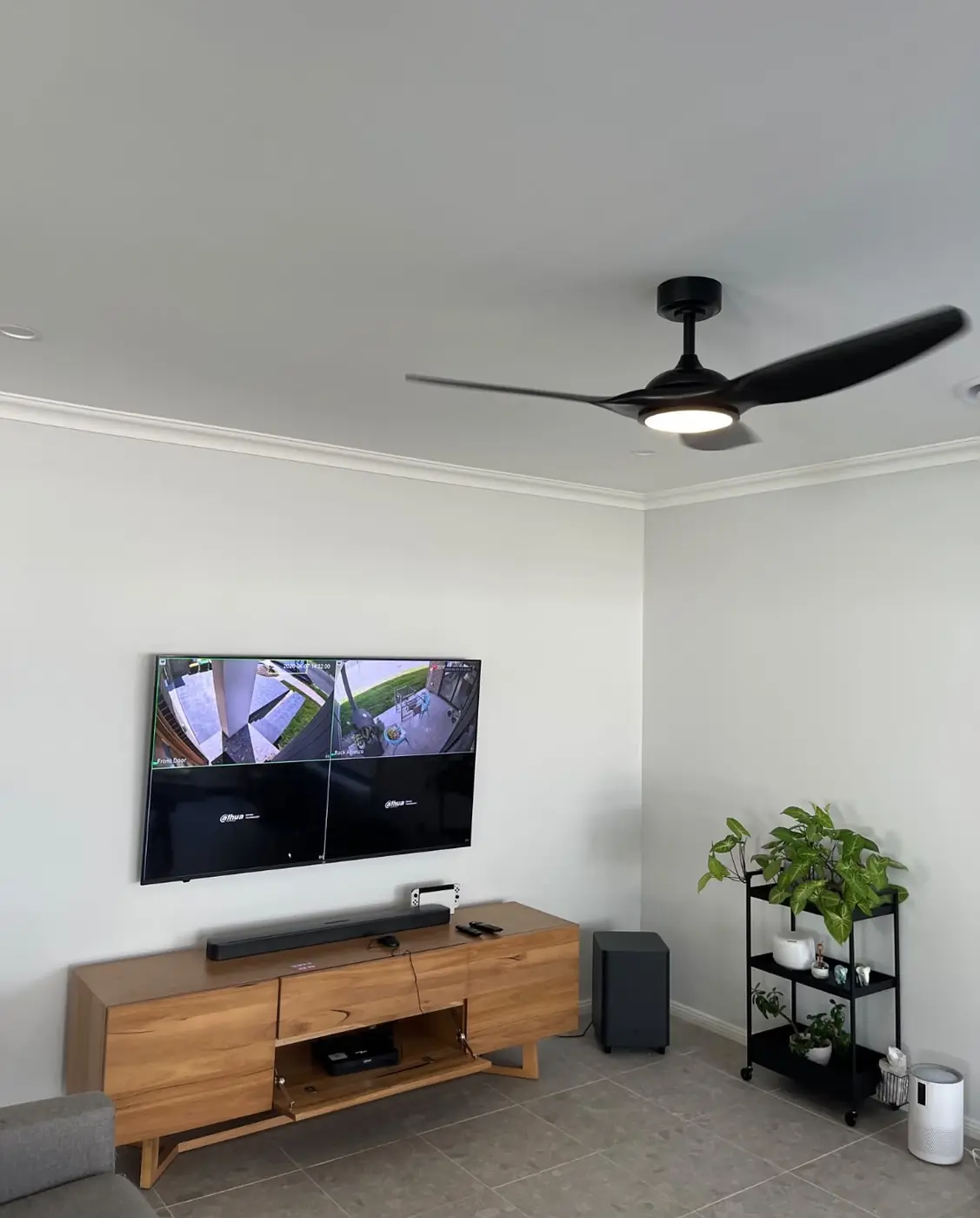 A wall-mounted television and soundbar installed in a living room by C3 Industries